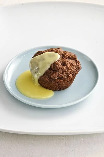 Warm chocolate muffin served as a dessert with custard sauce credit: Marie-Louise