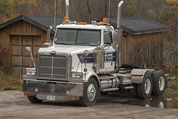 A white 6 x4 Western star tractor unit parked up at a rural Ontario timber yard