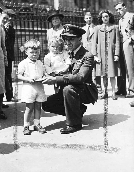 Wing Commander R. W. Cox of Aylesbury, Bucks pictured with his two children Jennifer aged 2