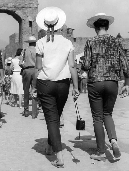 Two women tourists visiting Pompeii in Italy in the 1950s