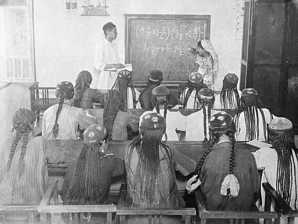 Women wearing long headdresses and plaits at a class in Tajikistan, Soviet Central Asia