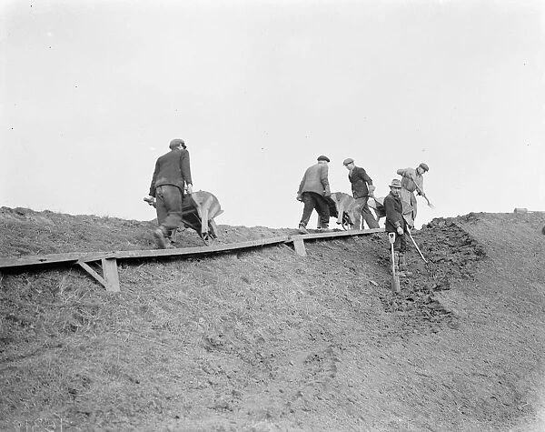 Workers increasing the river defences and doing repairs on the river wall and embankment