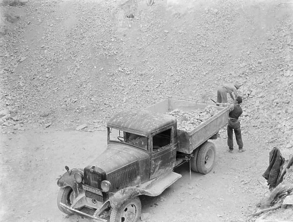 Workers are loading up a Bedford truck at the Lime Works in Dunton Green, Kent