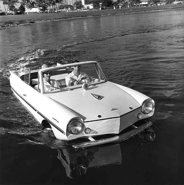 The Youngs cruise along in the lake. The entire body of the amphicar floats on both longitudinal