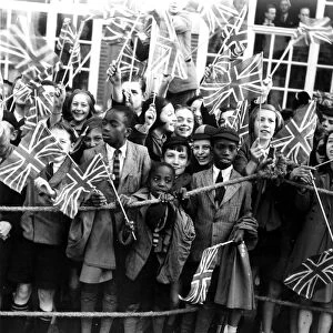 14 October 1938 Crowds of children cheering Queen Mary where she opened a new extension