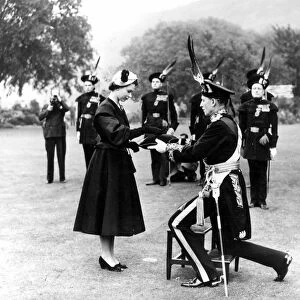 26th June 1952: Queen Elizabeth II being presented with a brooch by the Duke of Buccleuch