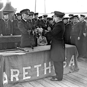 Aboard Arethusa training ship. Commander C. W. Bower (commanding Arethusa) presenting