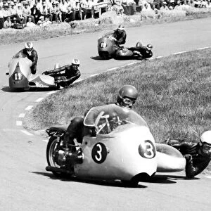 Assen, Holland: A scene from the sidecar TT here on June 25th: front to back, Edgar Strub