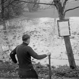 A boy looks at the flooded Sidcup swimming pool - flooded due to the bad weather