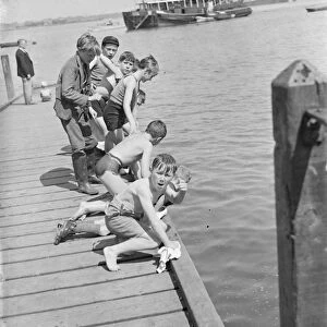 Boys play by the steps on the River Thames at Gravesend, Kent. 1939