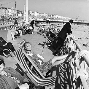 Brighton - enjoying the sunshine sitting in deckchairs on the Promenade at Brighton 28th