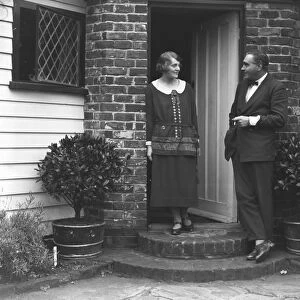 British film stars, Mr Henry Edwards and Miss Chrissie White at their front door