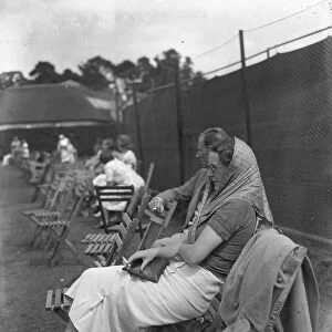 At the Brockenhurst Junior Tennis Tournament, Mrs Paul Peatling watches a match. 1937
