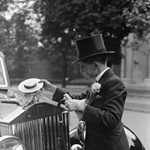 Bryan Adams, a Harrow boy with a Harrow hat car mascot at Lords where the Eton