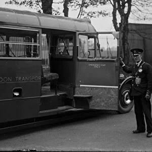 A bus conductor showing the large access door on a diesel bus, Longfield