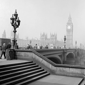 Cars and commuters making their way across Westminster Bridge towards Big Ben