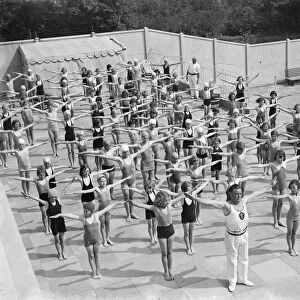 Children performing drills at the Swanscombe Baths in Kent. The instructor is Mr