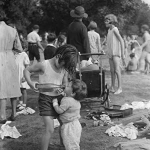 Children play in the paddling pools in Dartford park. 24 August 1937