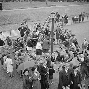Children playing on the top hat roundabout at the childrens playground in Crayford