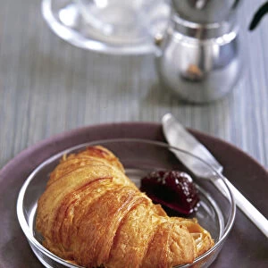 Croissant on glasss plate with cherry jam credit: Marie-Louise Avery / thePictureKitchen
