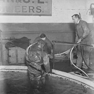 Demonstration of divers at work at Siebe. Gorman and Cos tanks at Westminster
