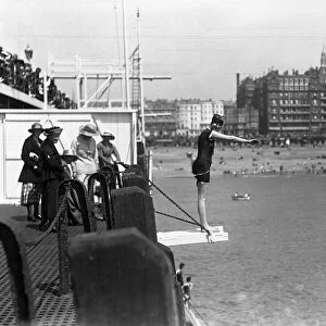 Diving off the pier during the Whitsun holiday at Brighton. 1920