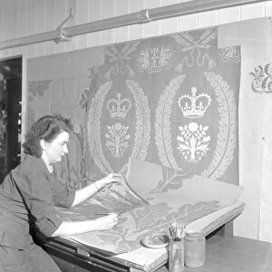 Draughtswoman Miss June Swindells working on designs for the draperies for the Coronation