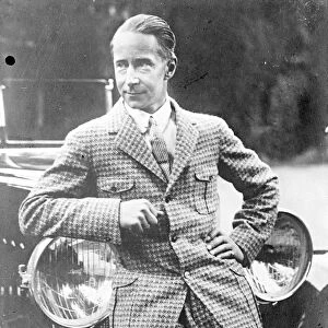 Ex-Crown Prince Wilhelm of Germany leaning on a car in his holiday suit. [son of
