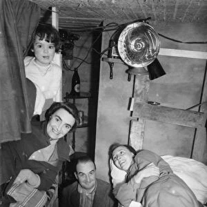 Family of five with their dog in an air raid shelter in Kent in WWII