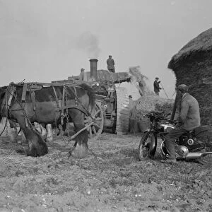 Farm workers in Farningham, Kent at work using a portable steam engine and belt-driven