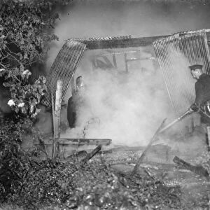 Firemen tend to a fire at the Bull in Chislehurst, Kent. 1939