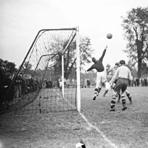 A football match in Swanley, Kent. Goalkeeper reaches for the ball