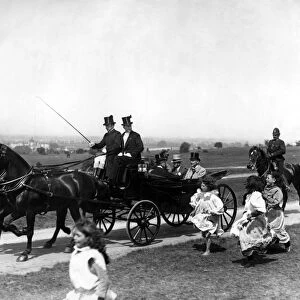 Gypsy children run after the Royal Carriage of King George V as they travel over