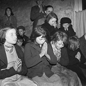 Gypsy childrens Sunday school in the cow shed in St Mary Cray. Children praying