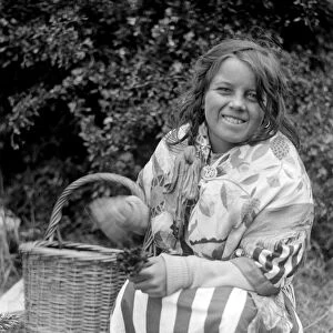 Gypsy girl with her basket of lucky heather. Late 1940s, early 1950s