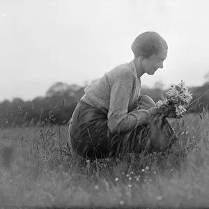 Haken. Miss Silhouette. Young woman picking wild flowers in a field. 1935