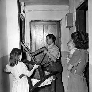 Helped by his 10 yesr old daughter Patricia, Mr Crome barricades the door of his