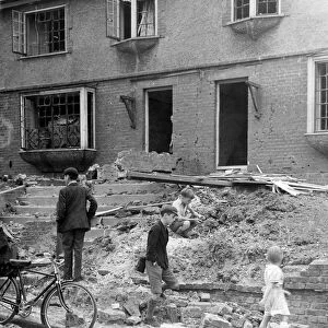 Home front 1940. Children in amongst the debris and rubble of Northfleet houses