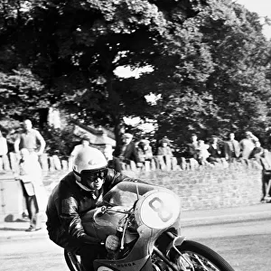 Isle of Man: N Taniguchi of Japan takes the corner at speed, riding a 125cc Japanese honda