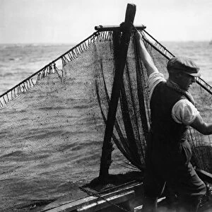 Jim Bradford preparing to haul in the shrimp nets - 1936 A TopFoto