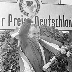 John Surtees celebrates victory for Ferrari in the German Grand Prix at Nurburgring