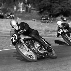 John Surtees Here pictured crouching around a corner on his way to win at Brands