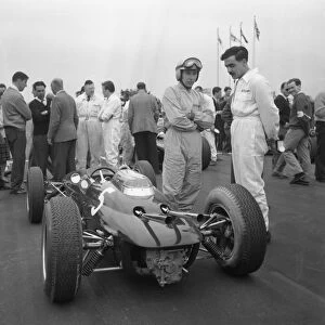 John Surtees stands next to his Lola Climax awaiting the start of the Goodwood International