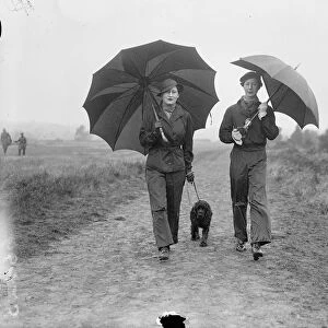 Lady Waleran (left) and Mrs Locker Lampson wearing waterproof trousers and carrying