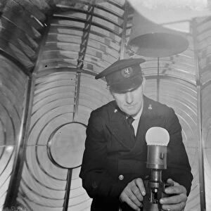 Lighthouse keeper J H Sole checks the Dungeness lighthouse bulb in the lantern room