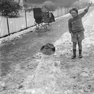 Little Peter Scott makes snowmen in St James Park 5 March 1922
