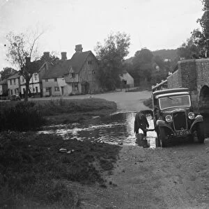 Locals wash their vehicle in the river in Eynsford. 1935