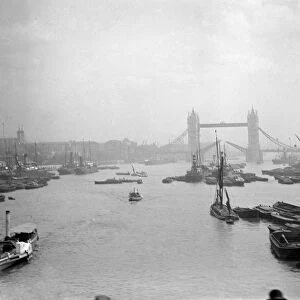 London. River Thames with barges and boats with the Tower Bridge in the back