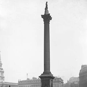 London street scene Nelsons Column in Trafalgar Square, London, England with Morley