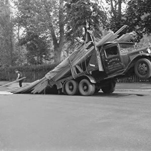 A lorry tips backwards spilling its load in Sevenoaks, Kent. 1935